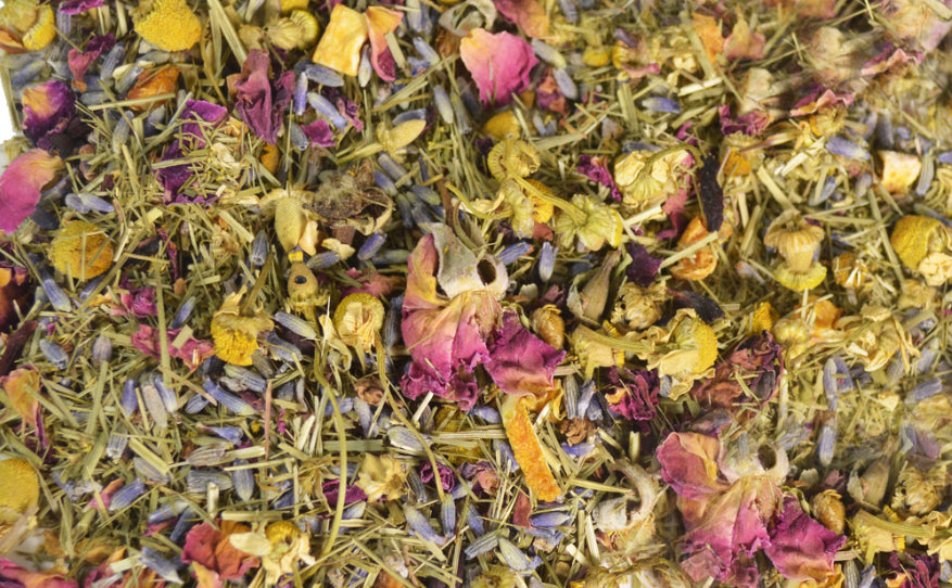 An image displaying a collection of bath tea herbs, showcasing a variety of dried botanicals and herbs used for a soothing and aromatic bath experience.